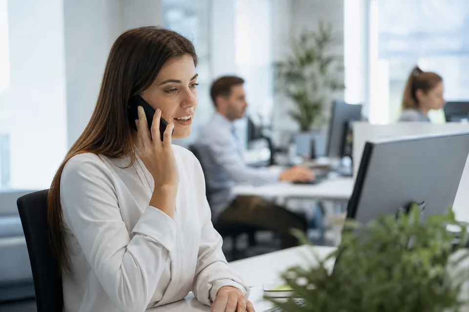 Inside sales rep on a quick call at a standing desk
