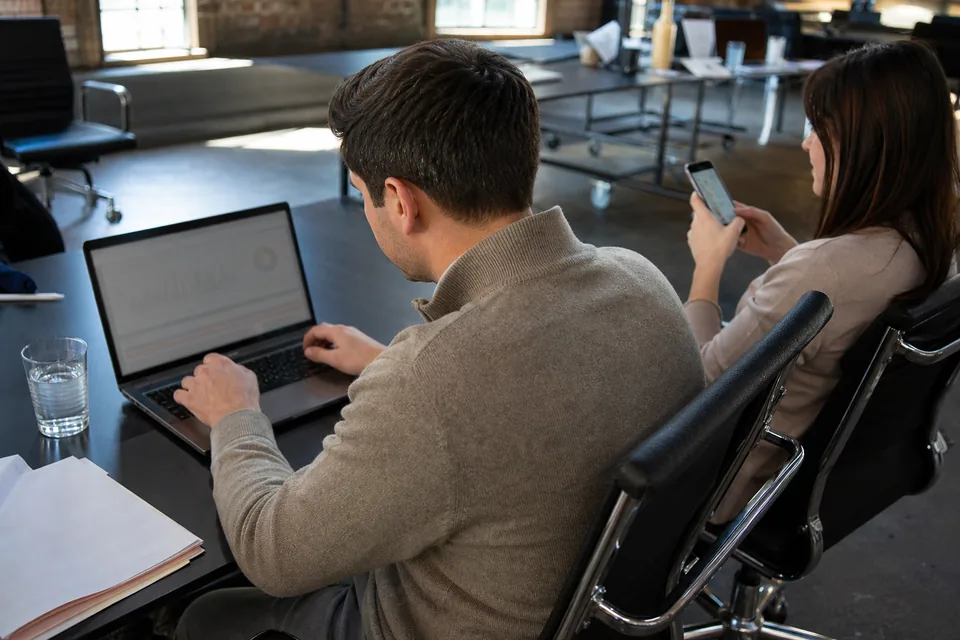 Sales operations manager moving a contact list to a new texting platform with a colleague